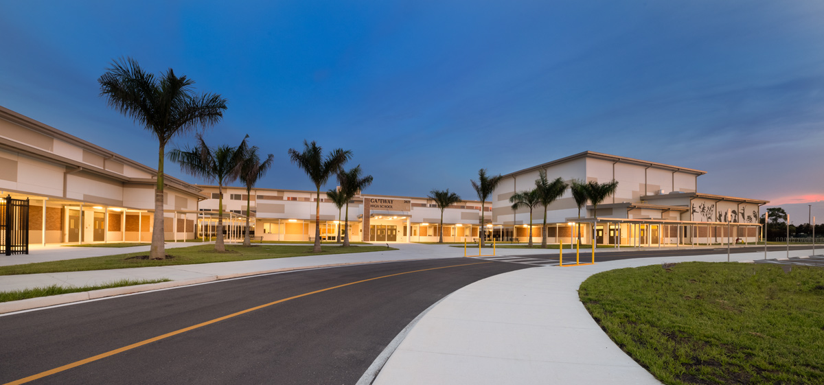 Architectural dusk view of the Gateway High School entrance in Fort Myers, FL.